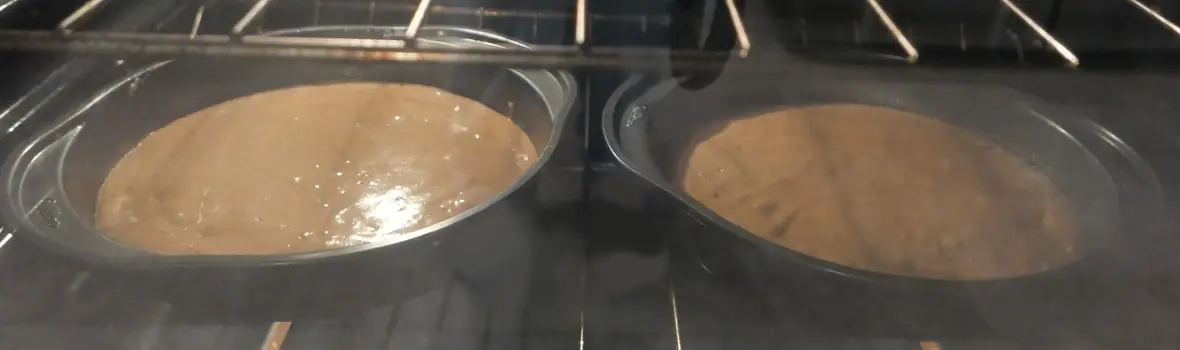 Two cake pans filled with batter.