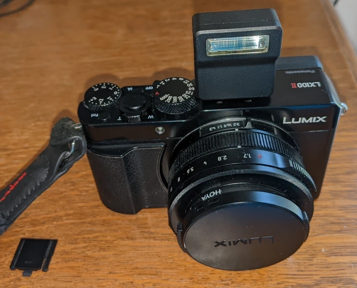 Photo of the LX100II with the flash module attached.
