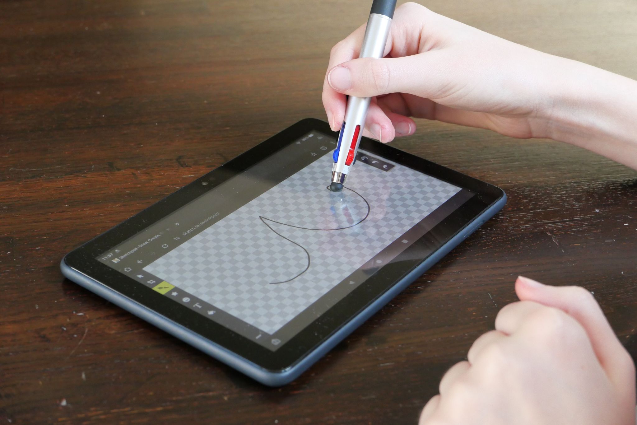 Photo of a hand drawing on a tablet with a passive stylus.