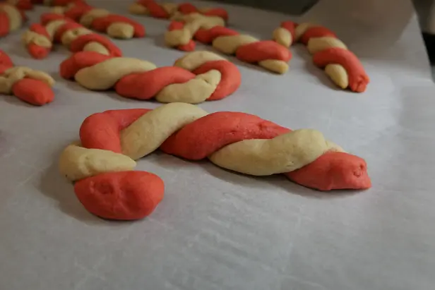 A cookie in the shape of a candy cane.